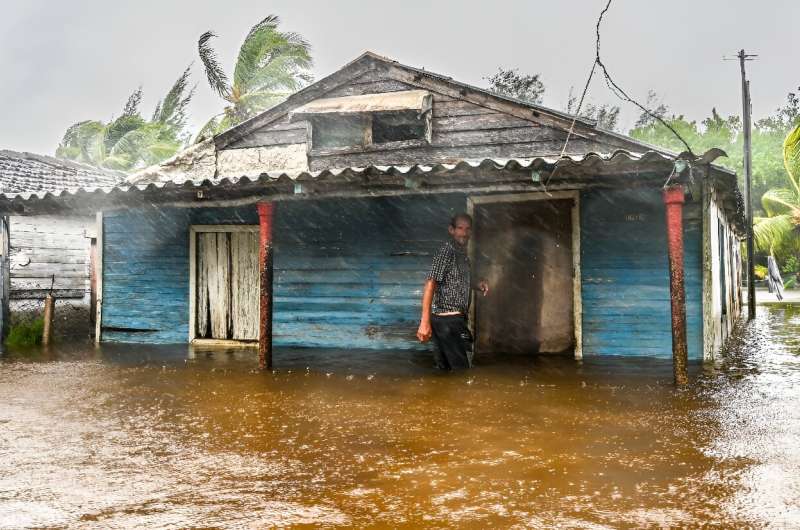 A man is seen outside his flooded house after the passage of Hurricane Helene in Guanimar, Artemisa province, Cuba, on September 25, 2024