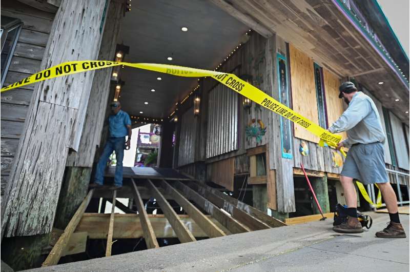 A restaurant owner closes the entrance to his establishment in Cedar Key, Florida as preparations are made for the arrival of Hurricane Helene. A restaurant owner closes the entrance to his establishment in Cedar Key, Florida as preparations are made for the arrival of Hurricane Helene