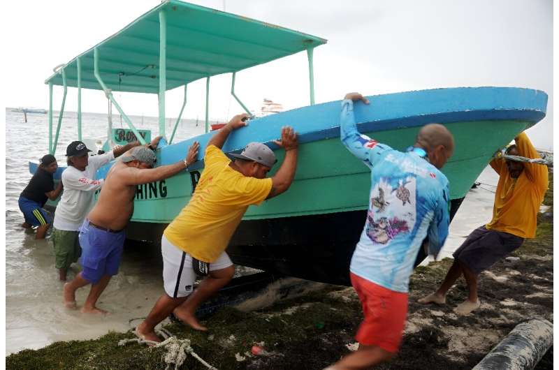 People secure their boats ahead of the arrival of Hurricane Helene in Cancun, Quintana Roo state, Mexico. People secure their boats ahead of the arrival of Hurricane Helene in Cancun, Quintana Roo state, Mexico
